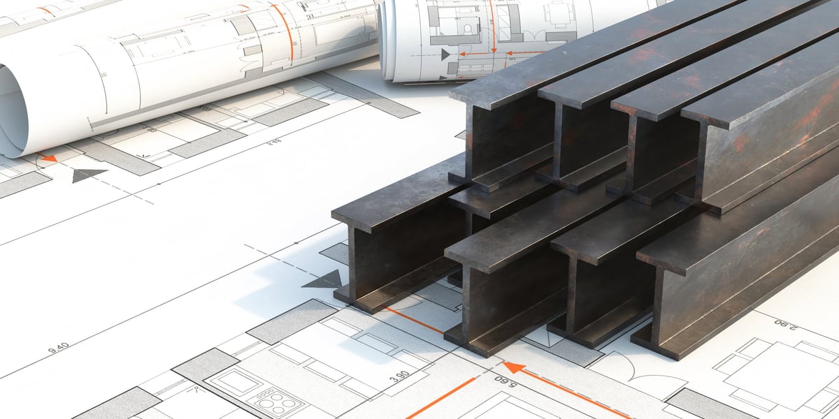 Steel beams stacked over construction blueprints and project planning documents