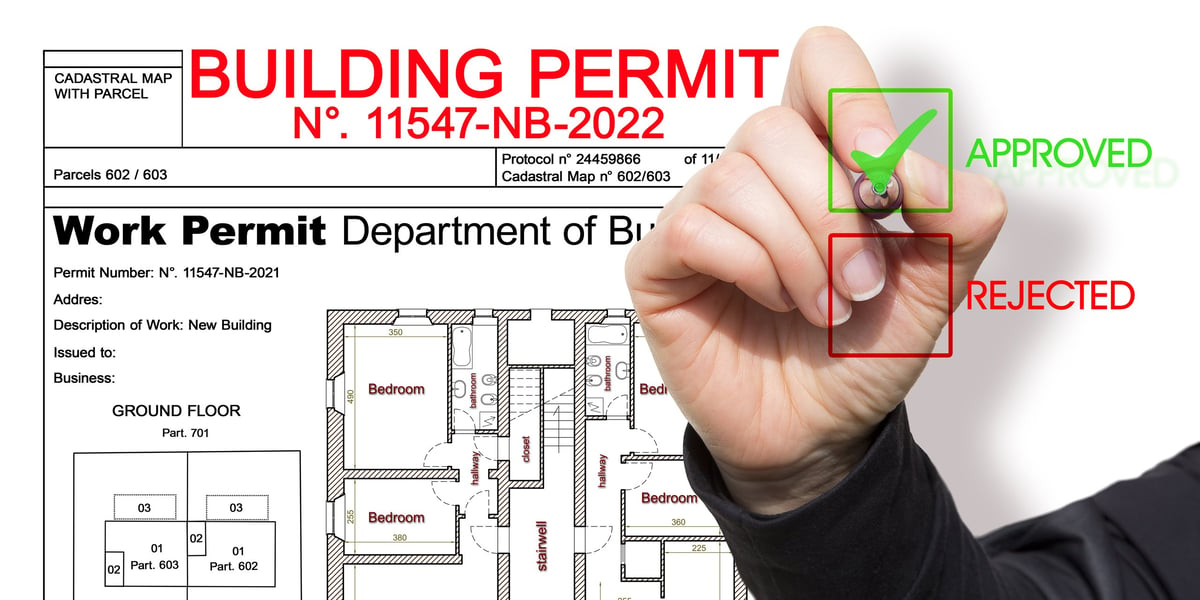 Approved building permit application with cadastral map on a construction desk in Ontario