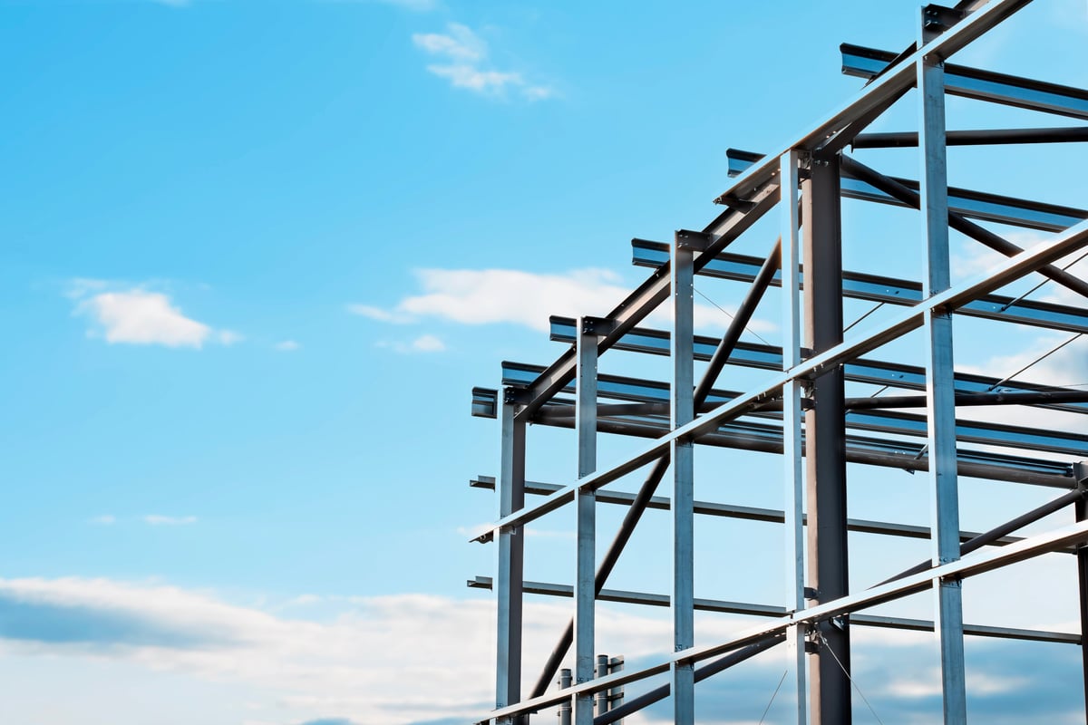 Structural steel framework being erected for a commercial building in an urban area